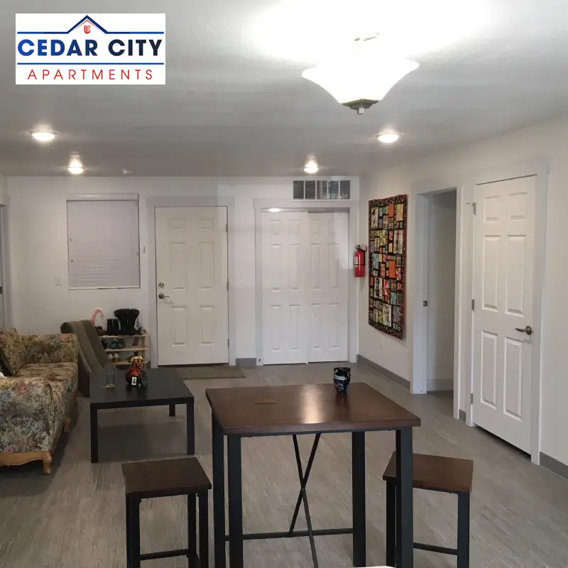 The living room of Cedar City Apartments with furniture and doors visible