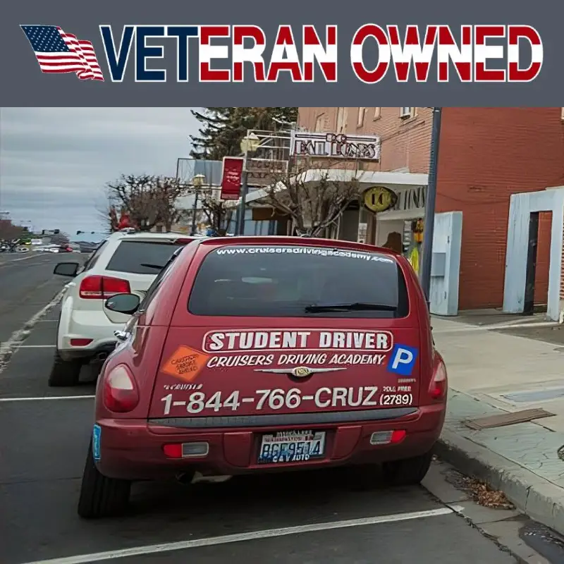 The back of a red car with the information of Cruisers Driving Academy printed on its body