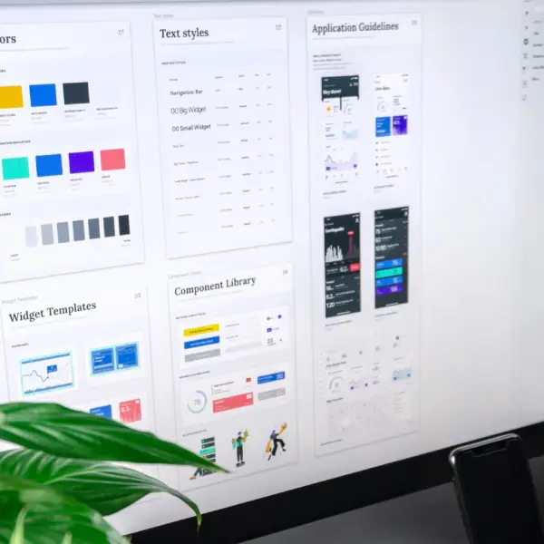 A computer monitor displaying design assets, including text styles, widget templates, component library, and application guidelines