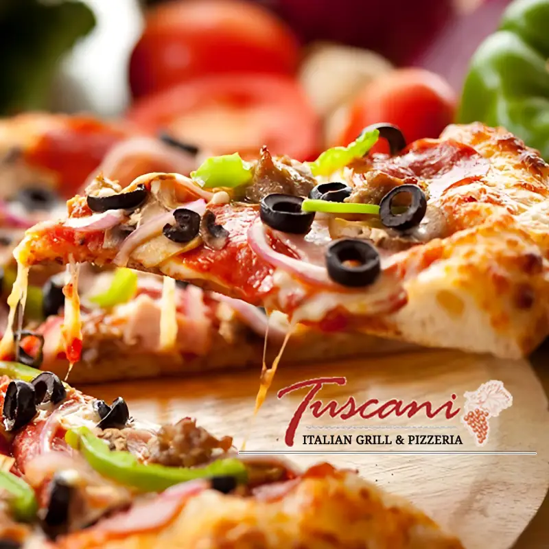 A slice of pizza with toppings of slices of olives, mushrooms, capsicum, and onions