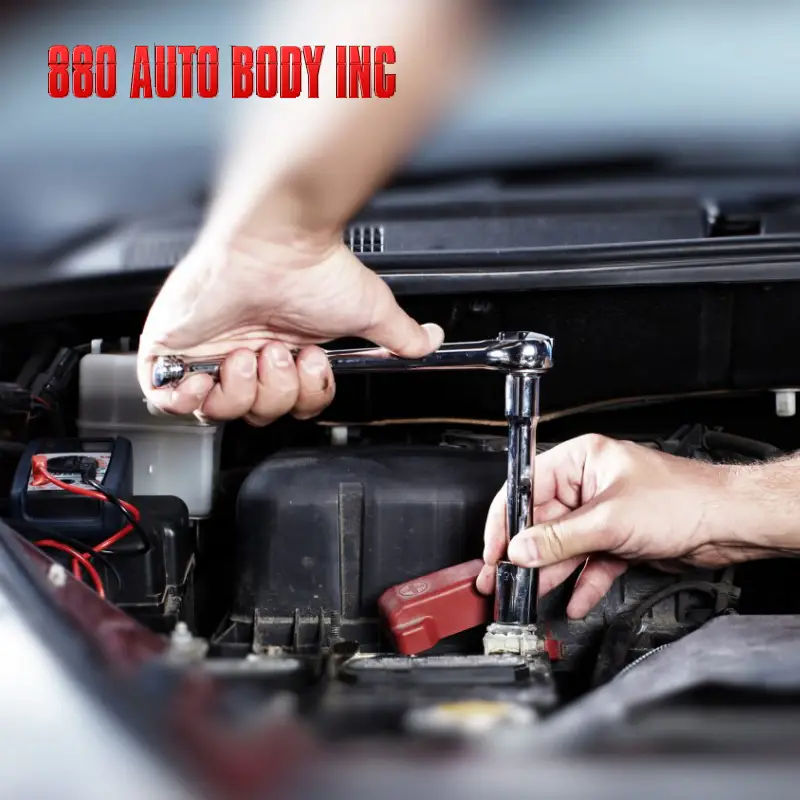 Hands of a mechanic working on a vehicle engine