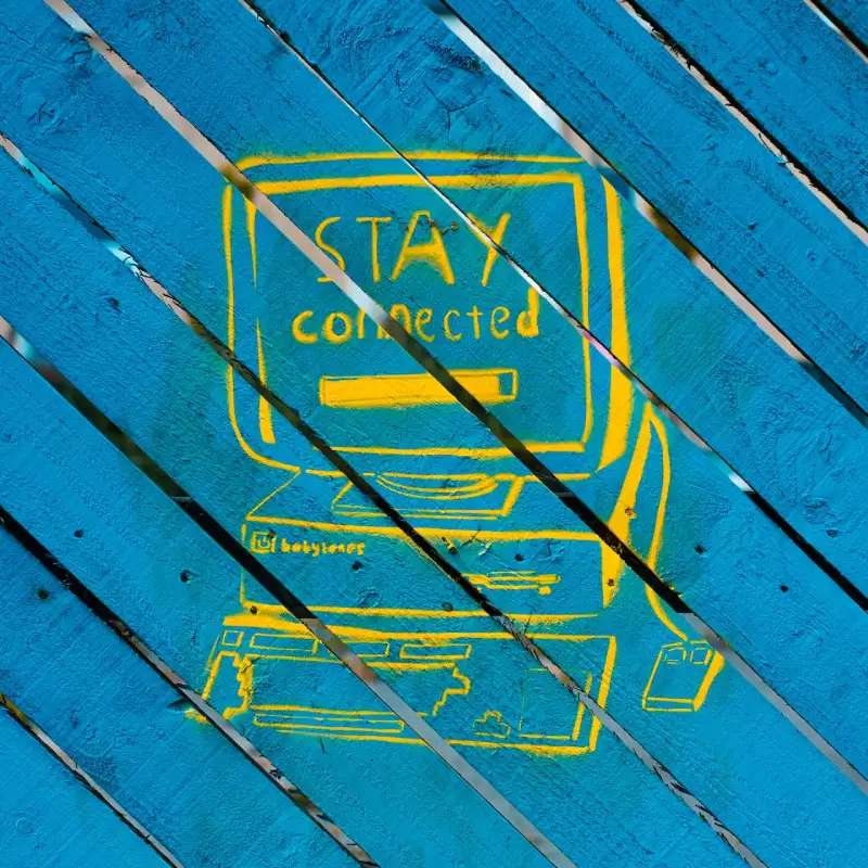 A graffiti of a computer painted on a blue wooden fence representing 99% uptime guarantee for website